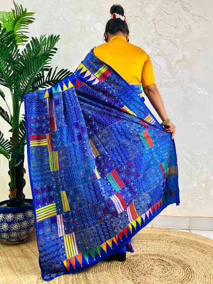 Back standing view of royal blue Kantha saree with pennant border pallu
