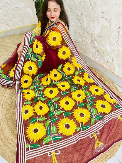 Woman wearing wine red hand-embroidered Kantha stitch sunflower saree, side seated pose