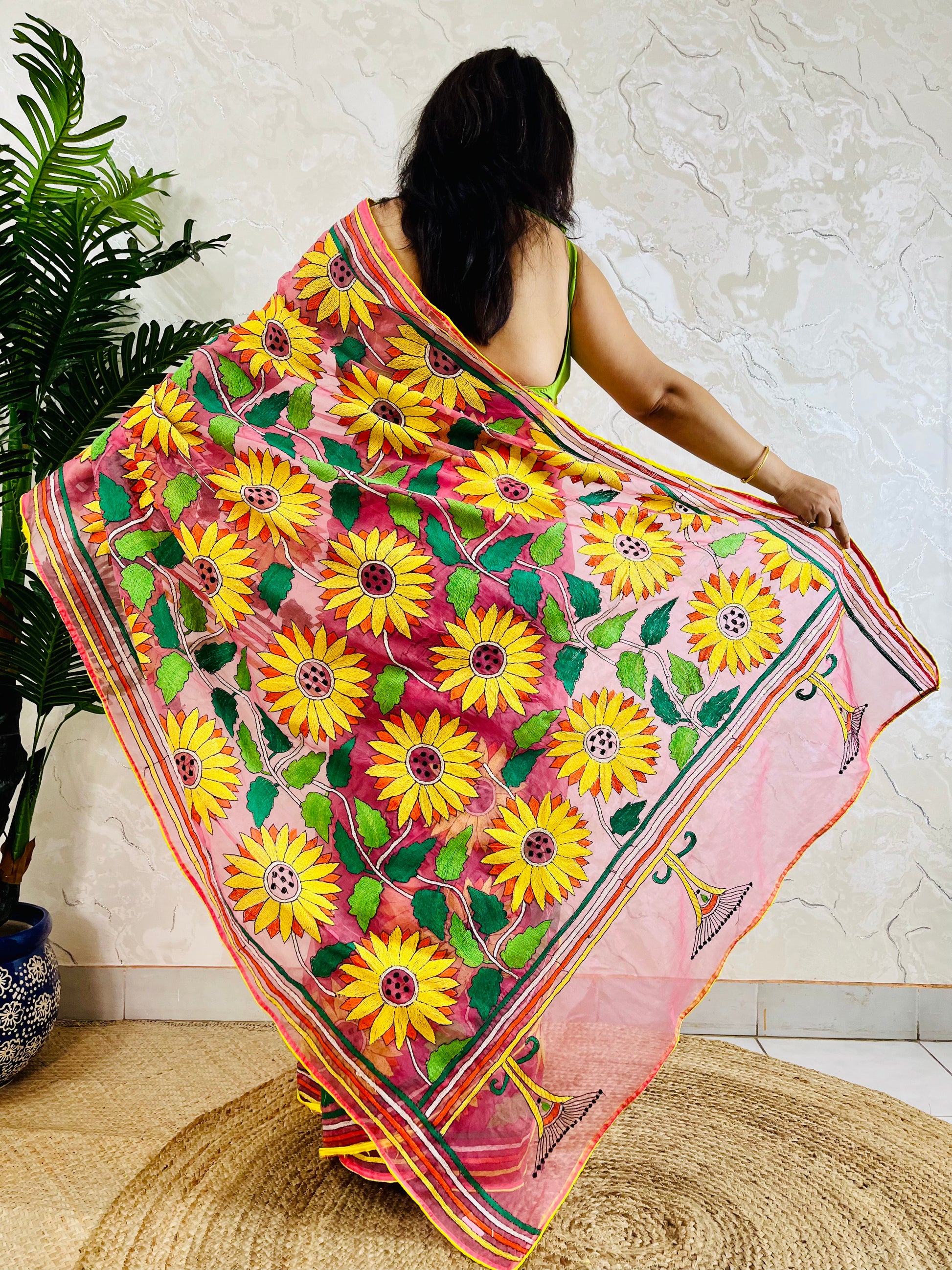 Baby pink organza saree with hand-stitched Sunflower Kantha embroidery, pallu spread showing floral detailing – Desi Aadat