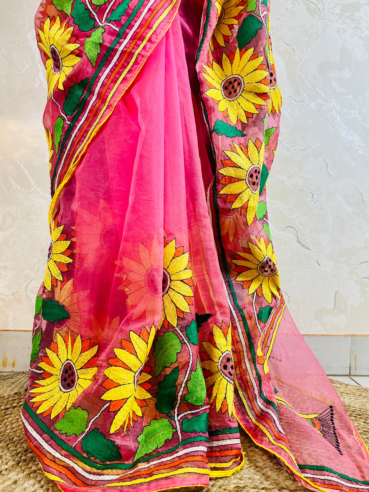 Close-up of hand-stitched Sunflower Kantha embroidery in mustard and green thread on baby pink organza saree – Desi Aadat