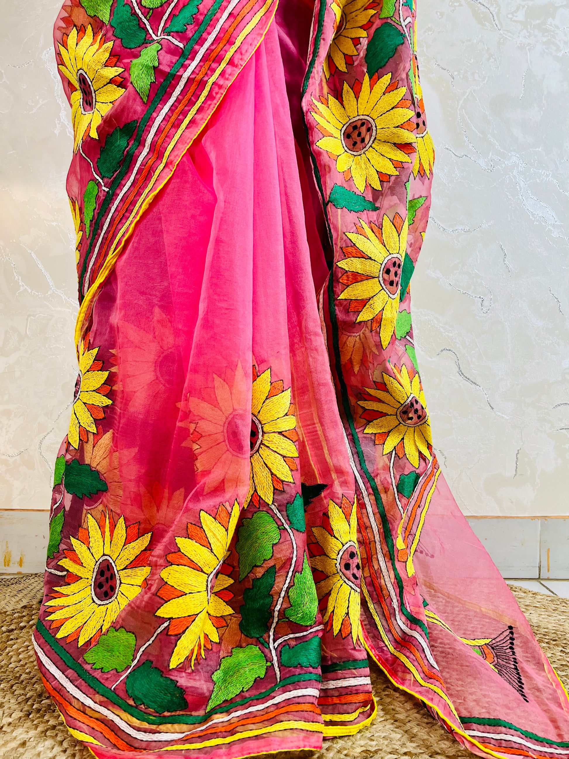 Close-up of hand-stitched Sunflower Kantha embroidery in mustard and green thread on baby pink organza saree – Desi Aadat