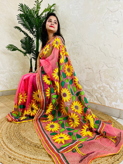 Woman seated in baby pink Kantha stitch organza saree with hand-embroidered sunflowers – Desi Aadat