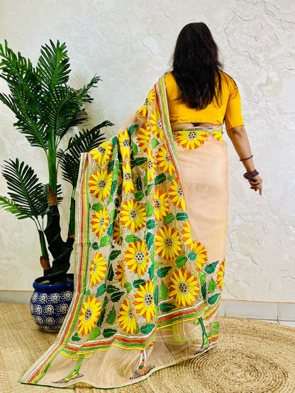 Light peach organza saree with sunflower embroidery, back standing view