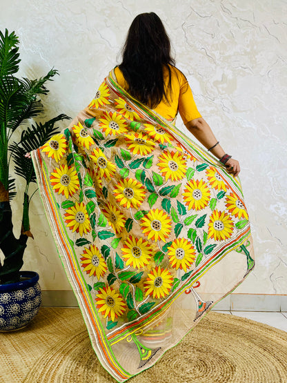 Light peach organza saree with sunflower embroidery, back standing view