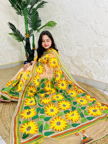 Woman seated in light peach sunflower Kantha stitch saree, top view