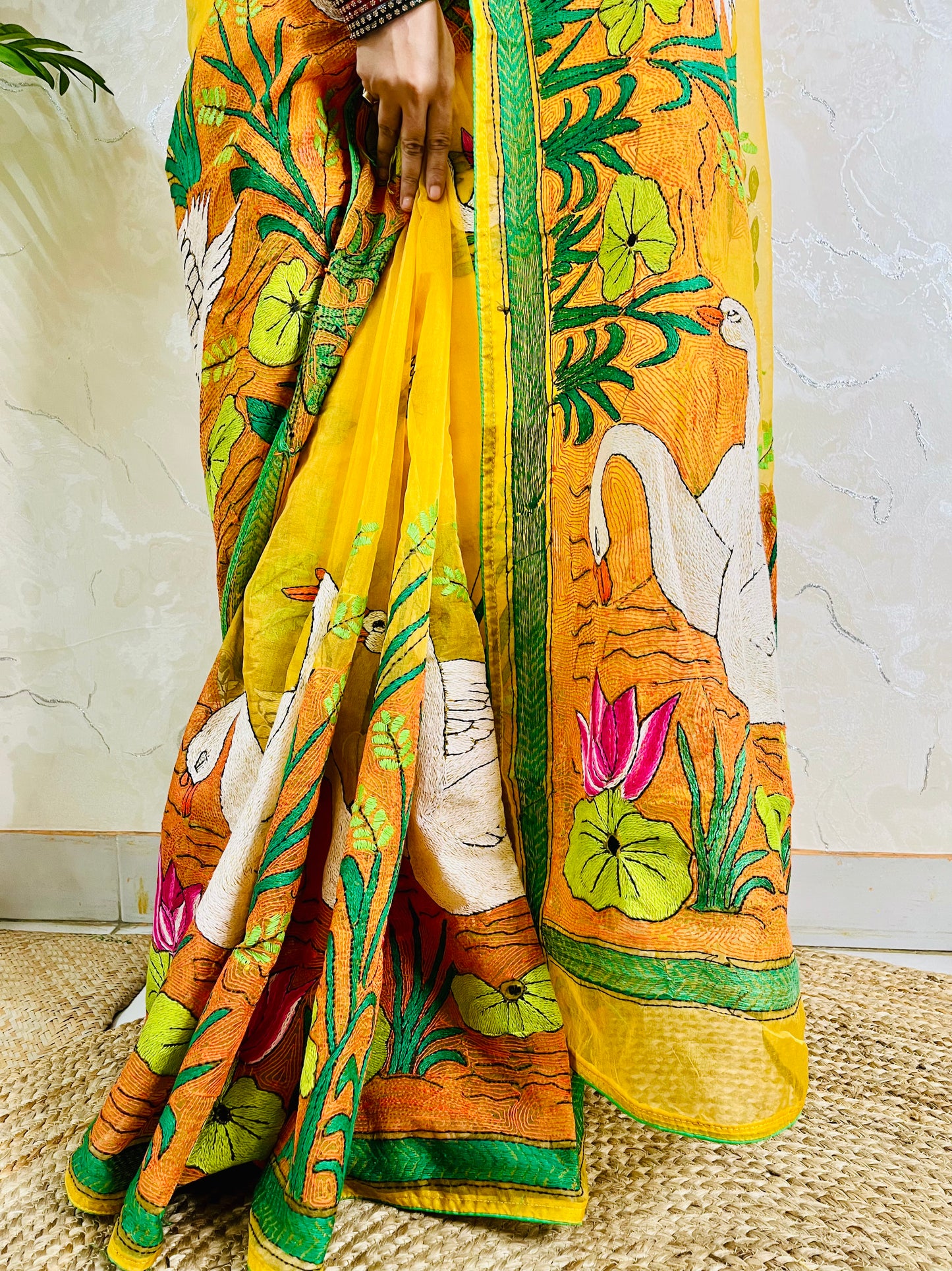 Close-up of hand-embroidered swan lotus Kantha stitch on sunshine yellow organza