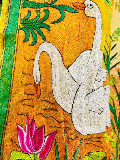 Close-up of hand-embroidered swan lotus Kantha stitch on sunshine yellow organza