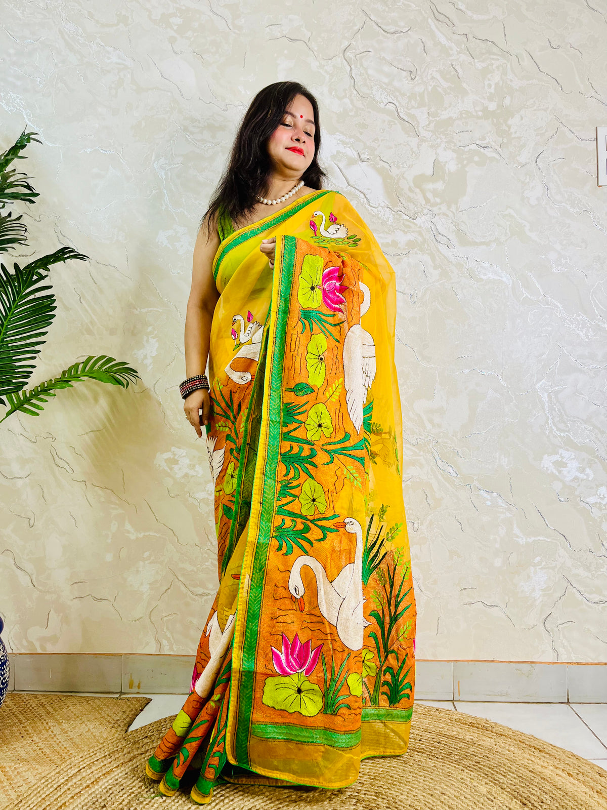 Sunshine yellow Kantha stitch saree with swan and lotus motif, front standing view