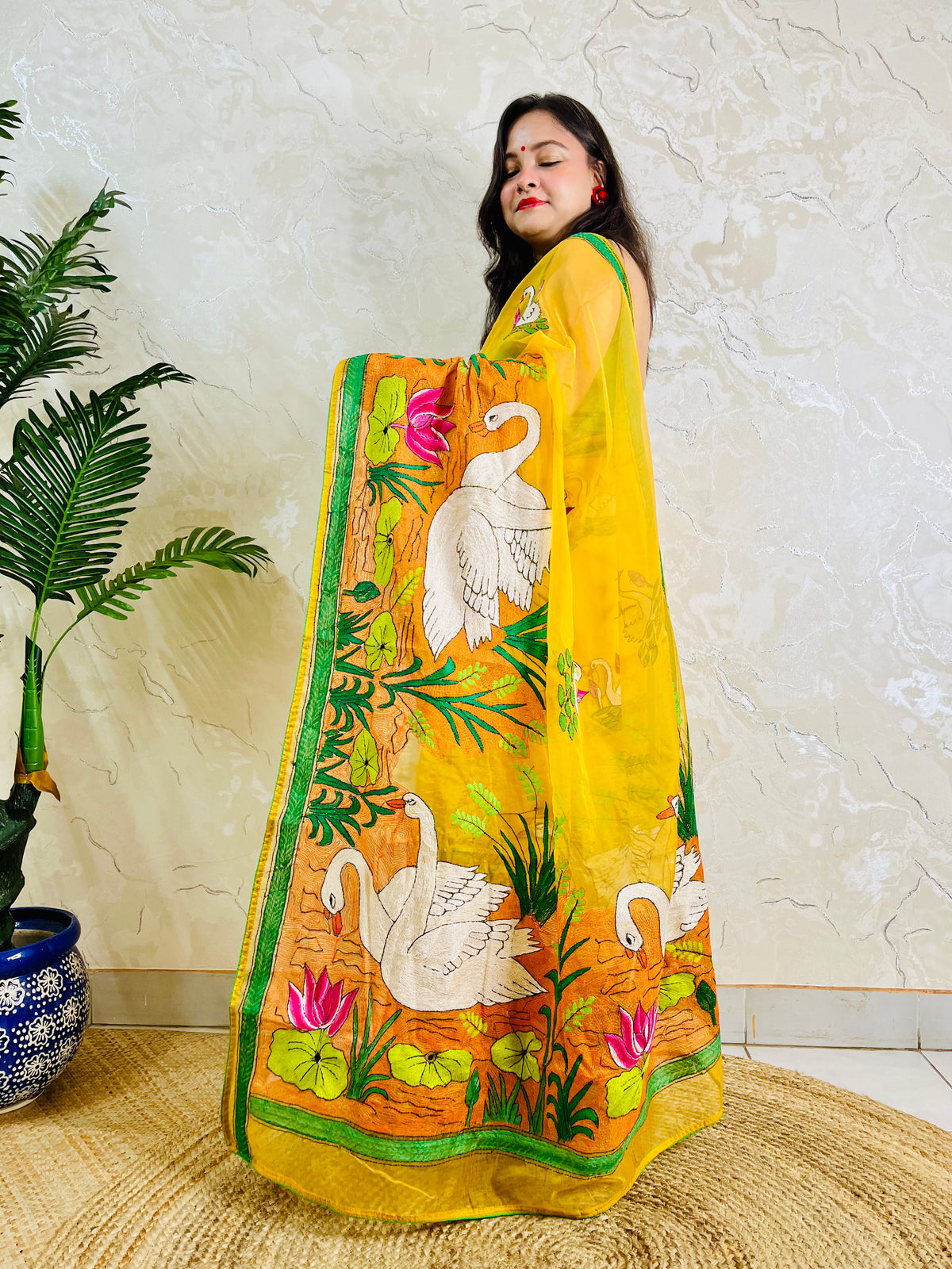 Sunshine yellow Kantha stitch saree with swan and lotus motif, front standing view
