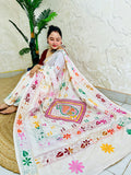 Woman seated in white Kantha stitch saree with paisley pallu spread out