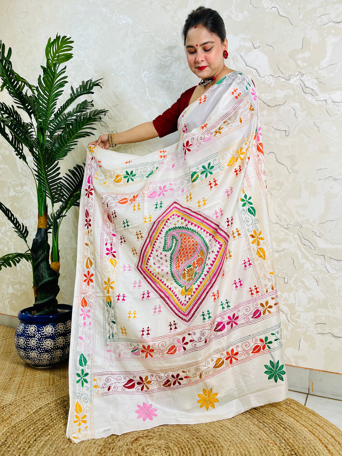 White handwoven saree draped standing pose with Kantha embroidery pallu detail