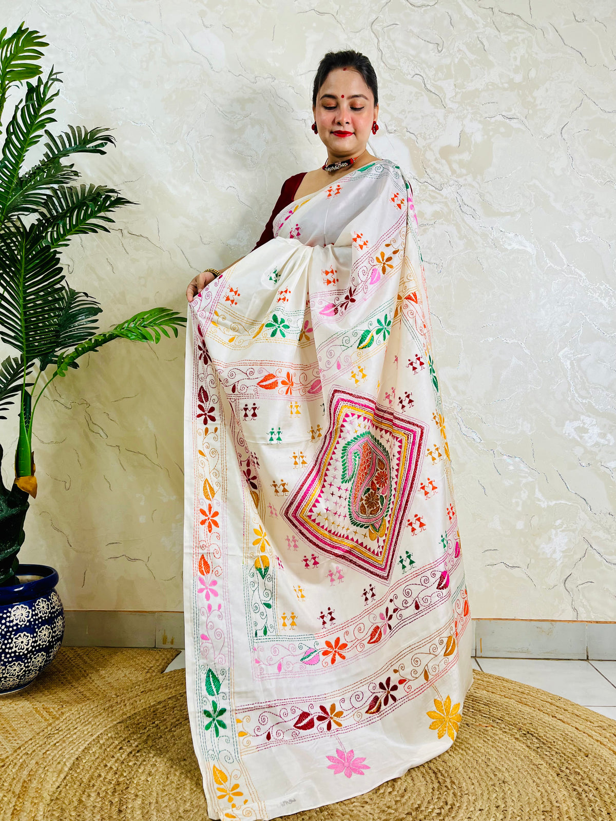 White handwoven saree draped standing pose with Kantha embroidery pallu detail