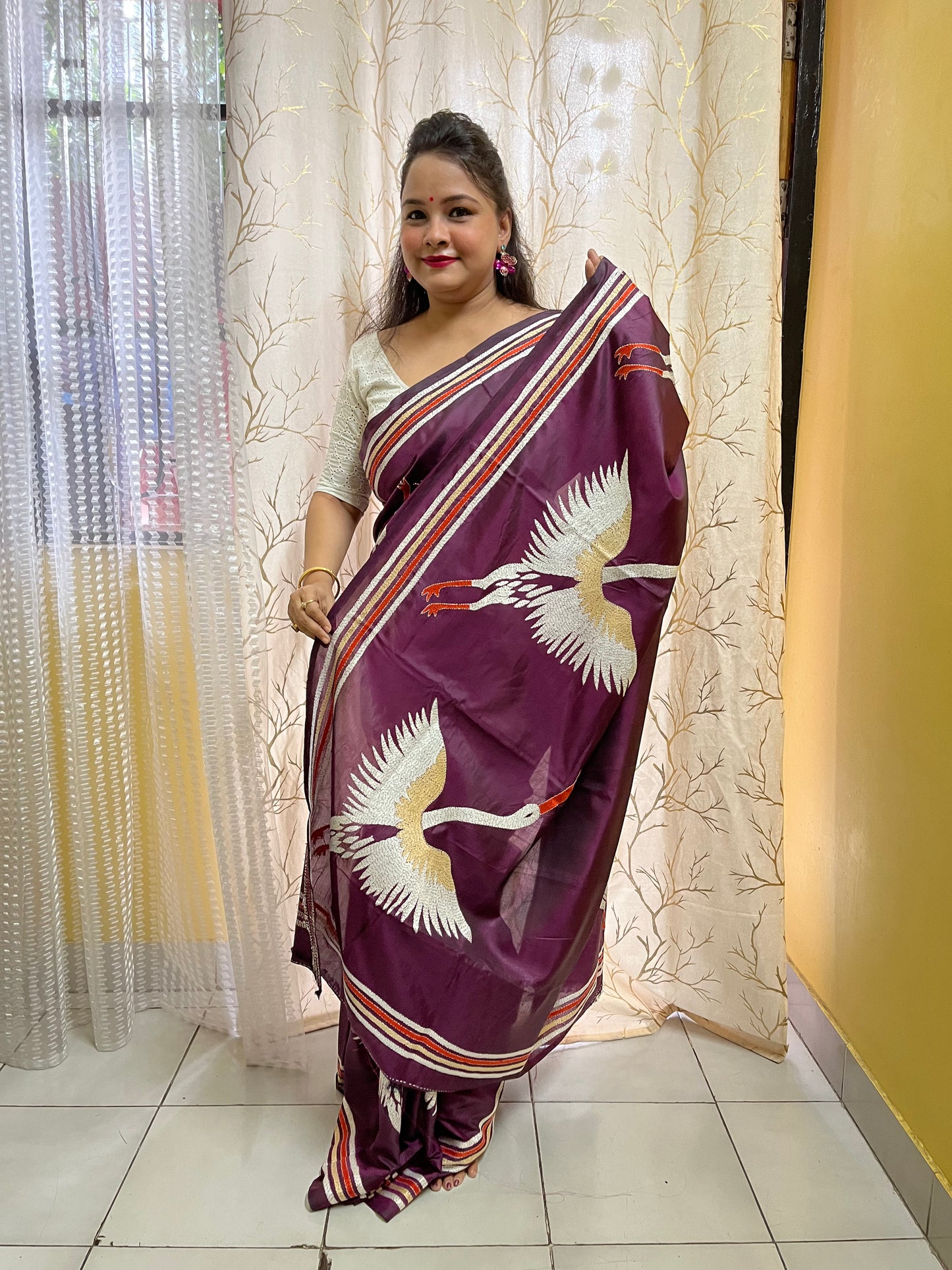 Beautiful woman wearing wine kantha stitch saree in traditional Indian styling