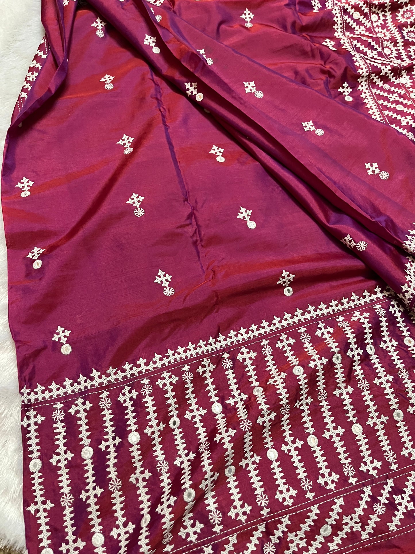 Detailed texture of handwoven Bangalore Silk with raised geometric embroidery and calculated mirror placement