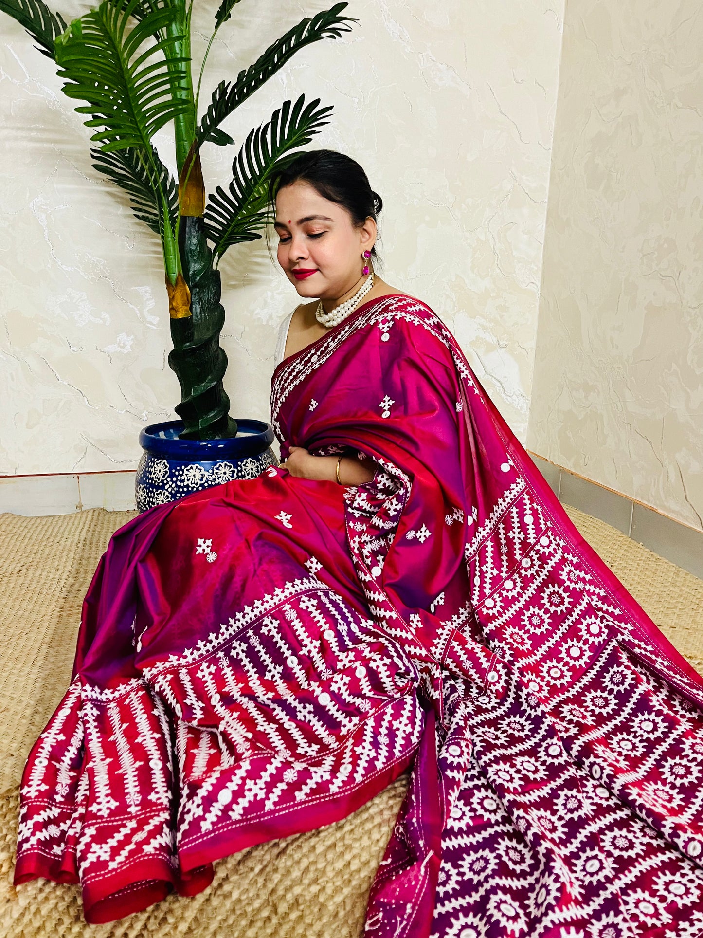 A women wearing Wine red Gujarati Stitch Saree with precise Kutch geometric hand embroidery and mirror work by Desi Aadat
