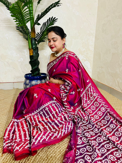 A women wearing Wine red Gujarati Stitch Saree with precise Kutch geometric hand embroidery and mirror work by Desi Aadat