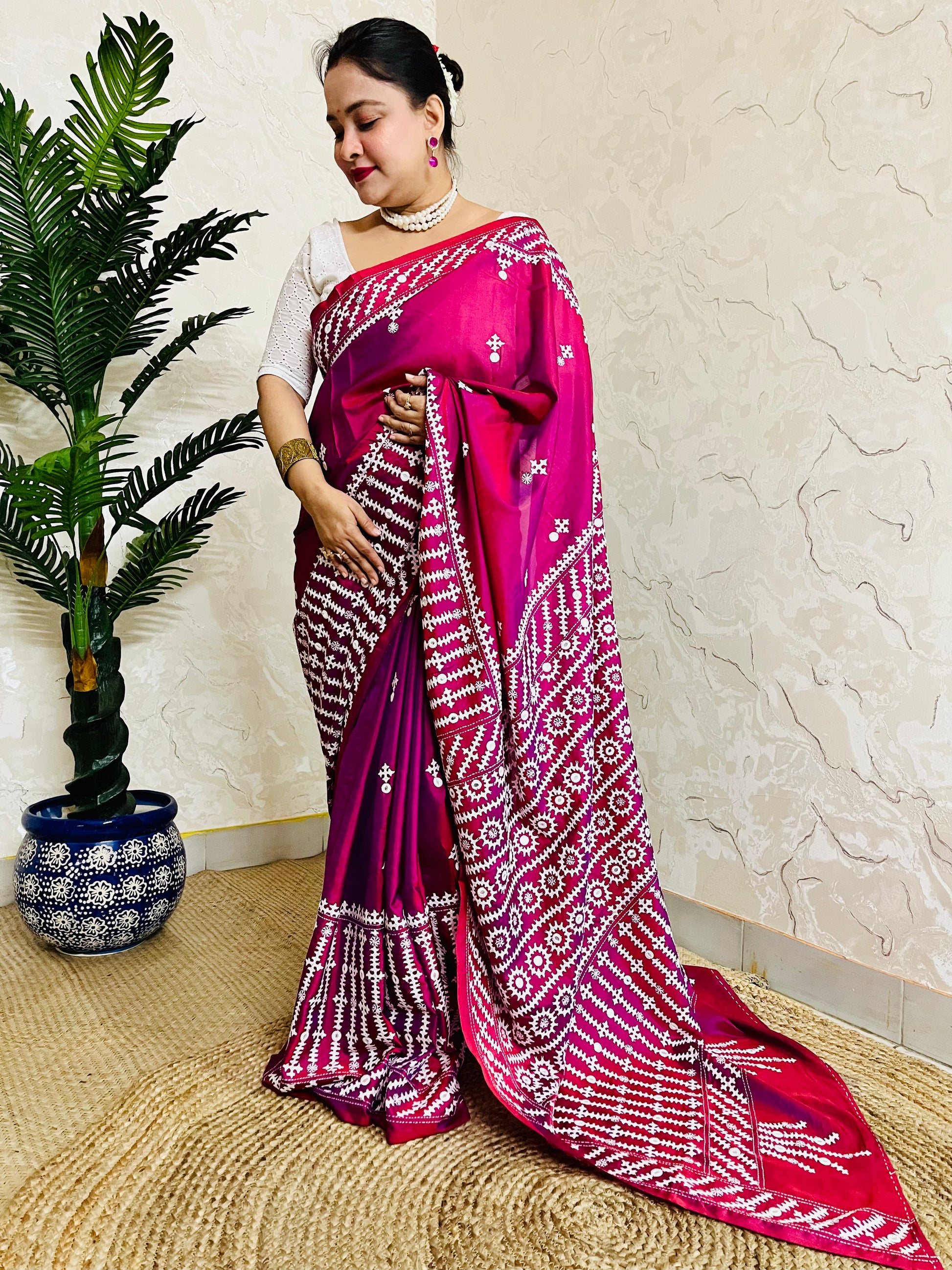 A women wearing Wine red Gujarati Stitch Saree with precise Kutch geometric hand embroidery and mirror work by Desi Aadat