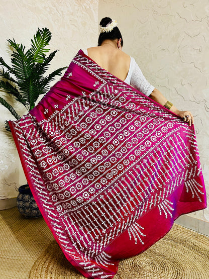 A women wearing Wine red Gujarati Stitch Saree with precise Kutch geometric hand embroidery and mirror work by Desi Aadat