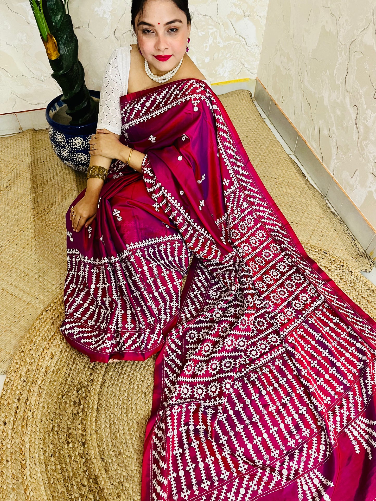 A women wearing Wine red Gujarati Stitch Saree with precise Kutch geometric hand embroidery and mirror work by Desi Aadat