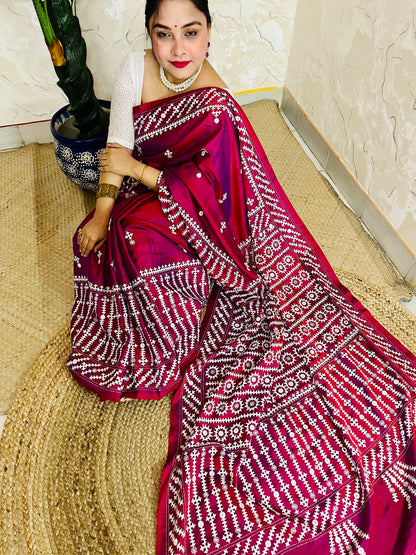 A women wearing Wine red Gujarati Stitch Saree with precise Kutch geometric hand embroidery and mirror work by Desi Aadat