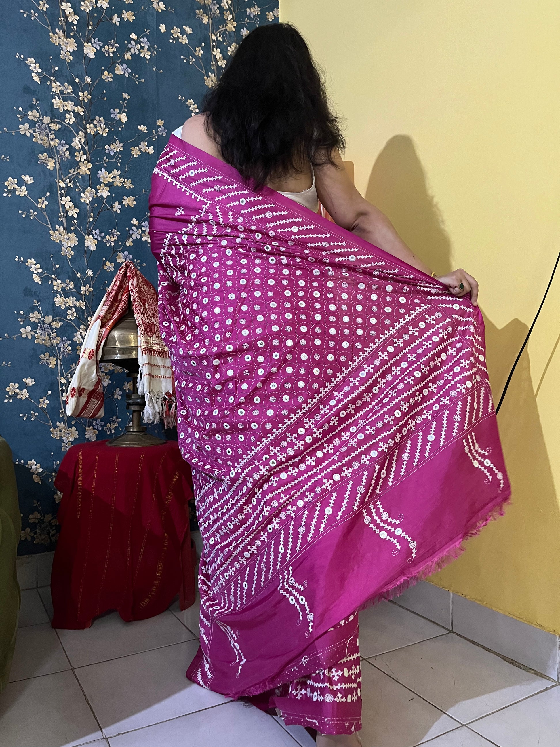 A model wearing a Burgundy Gujarati Stitch Saree with authentic Kutch hand embroidery and royal mirror work by Desi Aadat