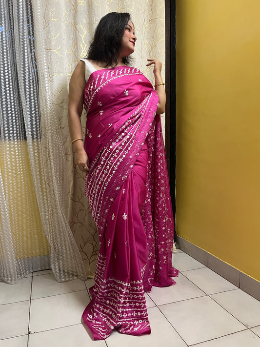 A model wearing a Burgundy Gujarati Stitch Saree with authentic Kutch hand embroidery and royal mirror work by Desi Aadat