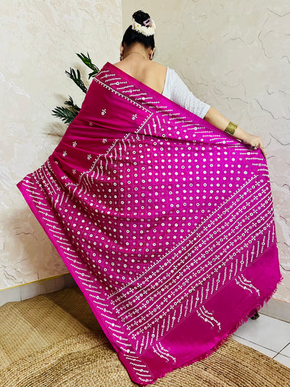 A model wearing a Burgundy Gujarati Stitch Saree with authentic Kutch hand embroidery and royal mirror work by Desi Aadat