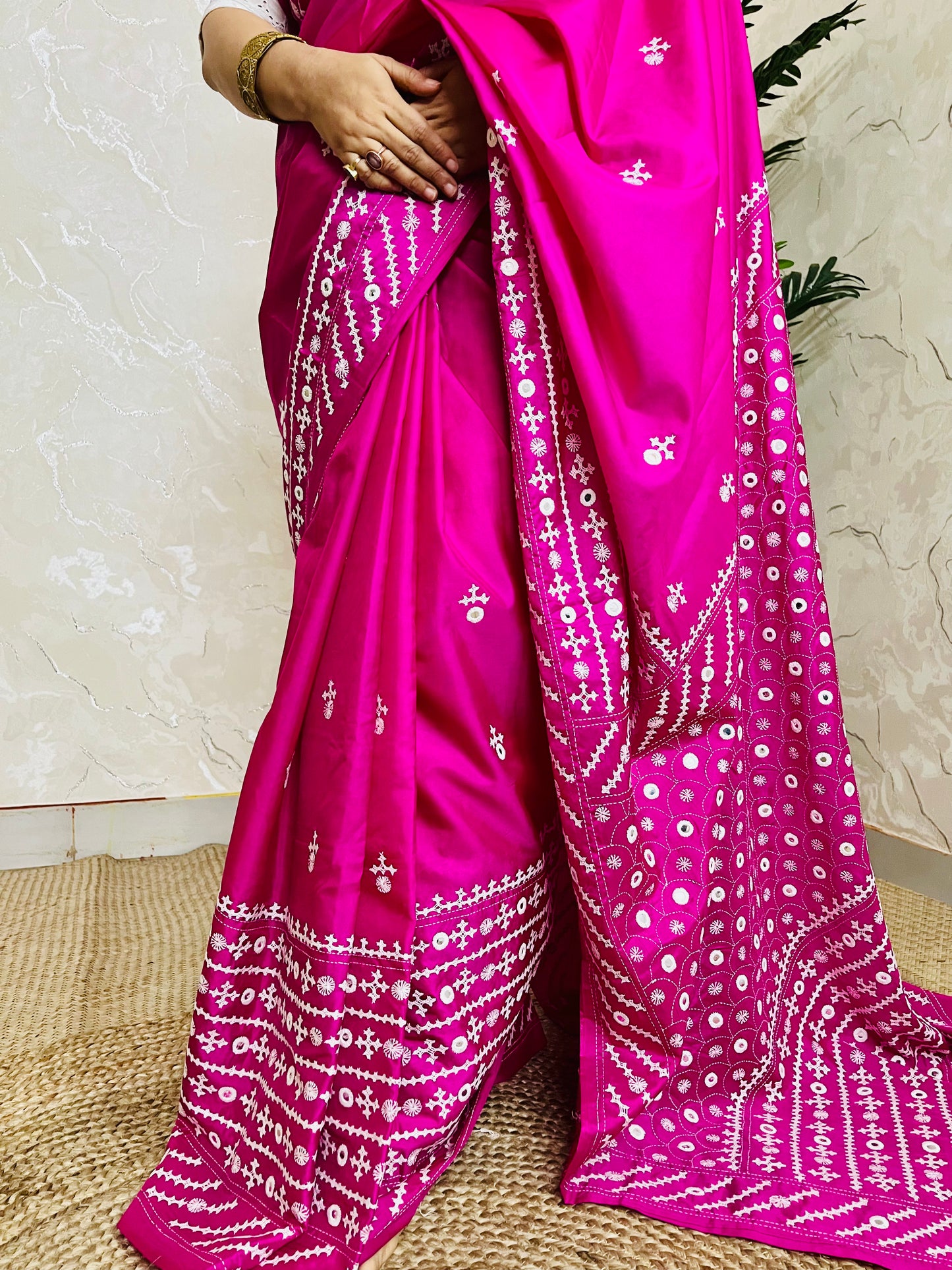 A model wearing a Burgundy Gujarati Stitch Saree with authentic Kutch hand embroidery and royal mirror work by Desi Aadat