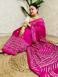 A model wearing a Burgundy Gujarati Stitch Saree with authentic Kutch hand embroidery and royal mirror work by Desi Aadat