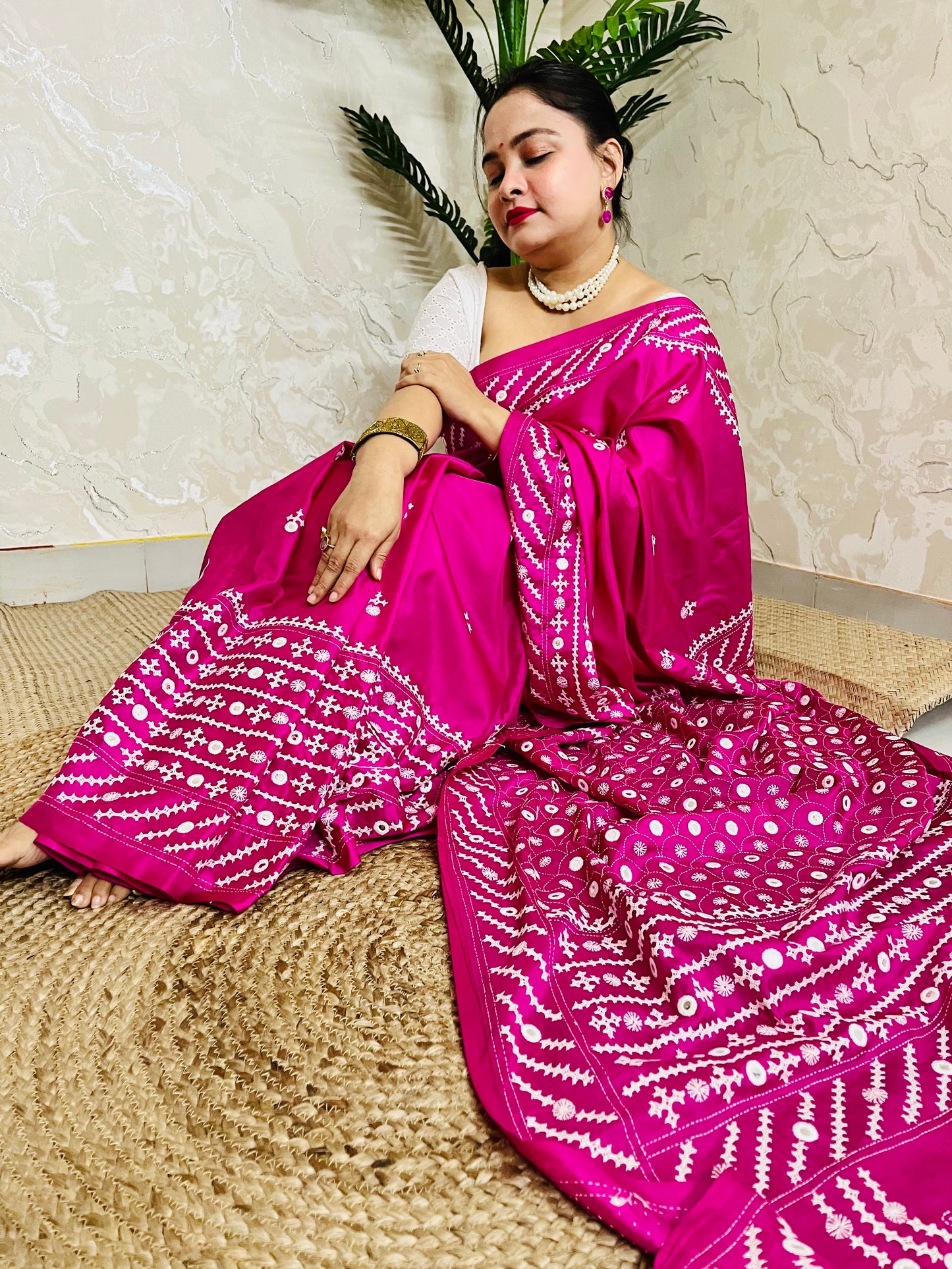 A model wearing a Burgundy Gujarati Stitch Saree with authentic Kutch hand embroidery and royal mirror work by Desi Aadat