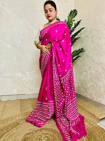 A model wearing a Burgundy Gujarati Stitch Saree with authentic Kutch hand embroidery and royal mirror work by Desi Aadat