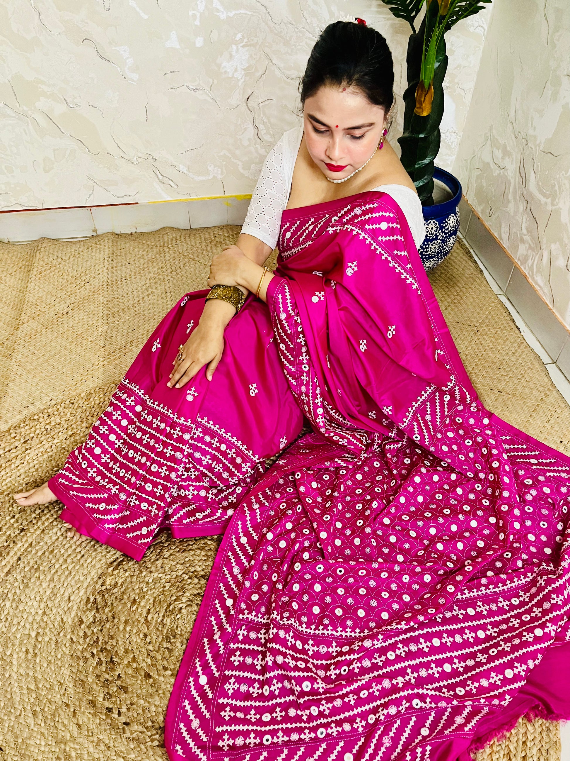 A model wearing a Burgundy Gujarati Stitch Saree with authentic Kutch hand embroidery and royal mirror work by Desi Aadat