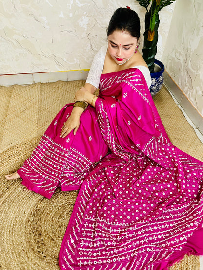 A model wearing a Burgundy Gujarati Stitch Saree with authentic Kutch hand embroidery and royal mirror work by Desi Aadat