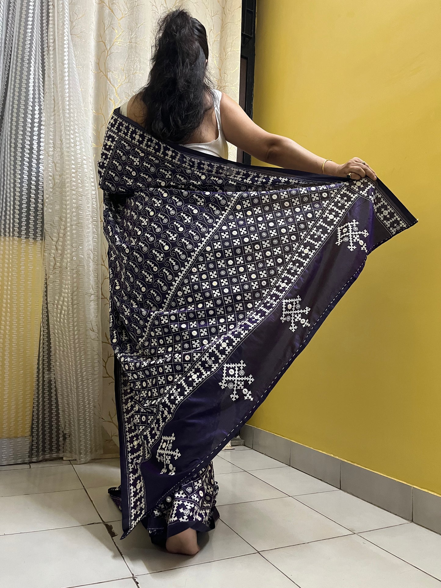 Model wearing a Violet Gujarati Stitch Saree with authentic Kutch hand embroidery and mirror work by Desi Aadat artisans back view
