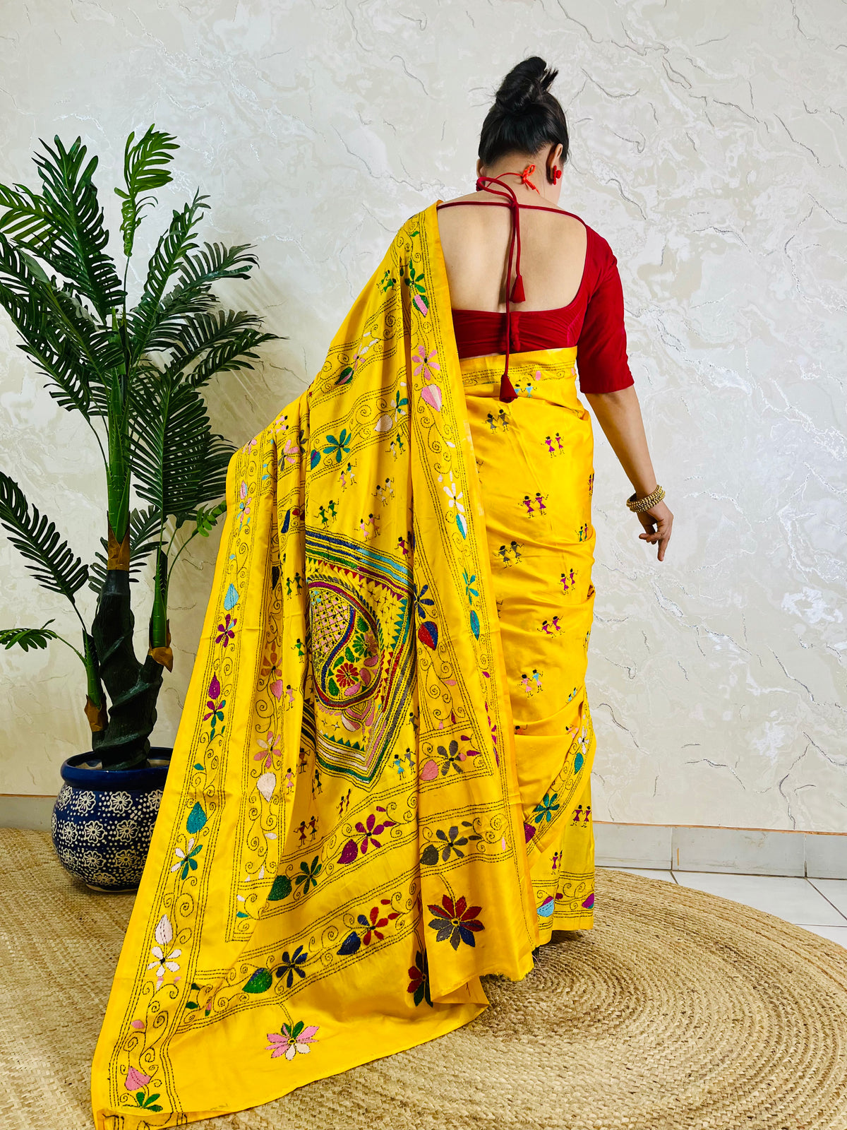 Back view of yellow Kantha saree with dancing figure motifs on Bangalore silk