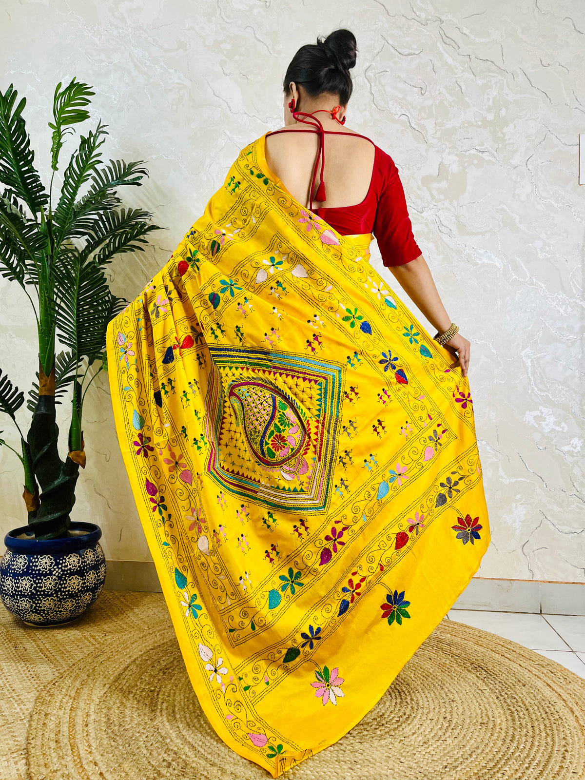 Back view of yellow Kantha saree with dancing figure motifs on Bangalore silk