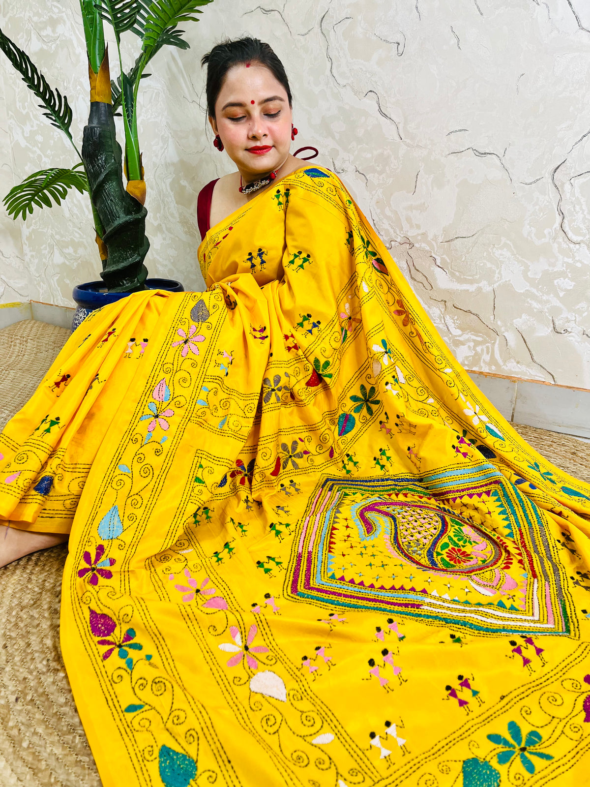 Yellow Kantha stitch saree with paisley pallu, full drape seated pose