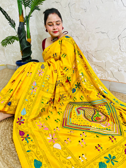 Yellow Kantha stitch saree with paisley pallu, full drape seated pose