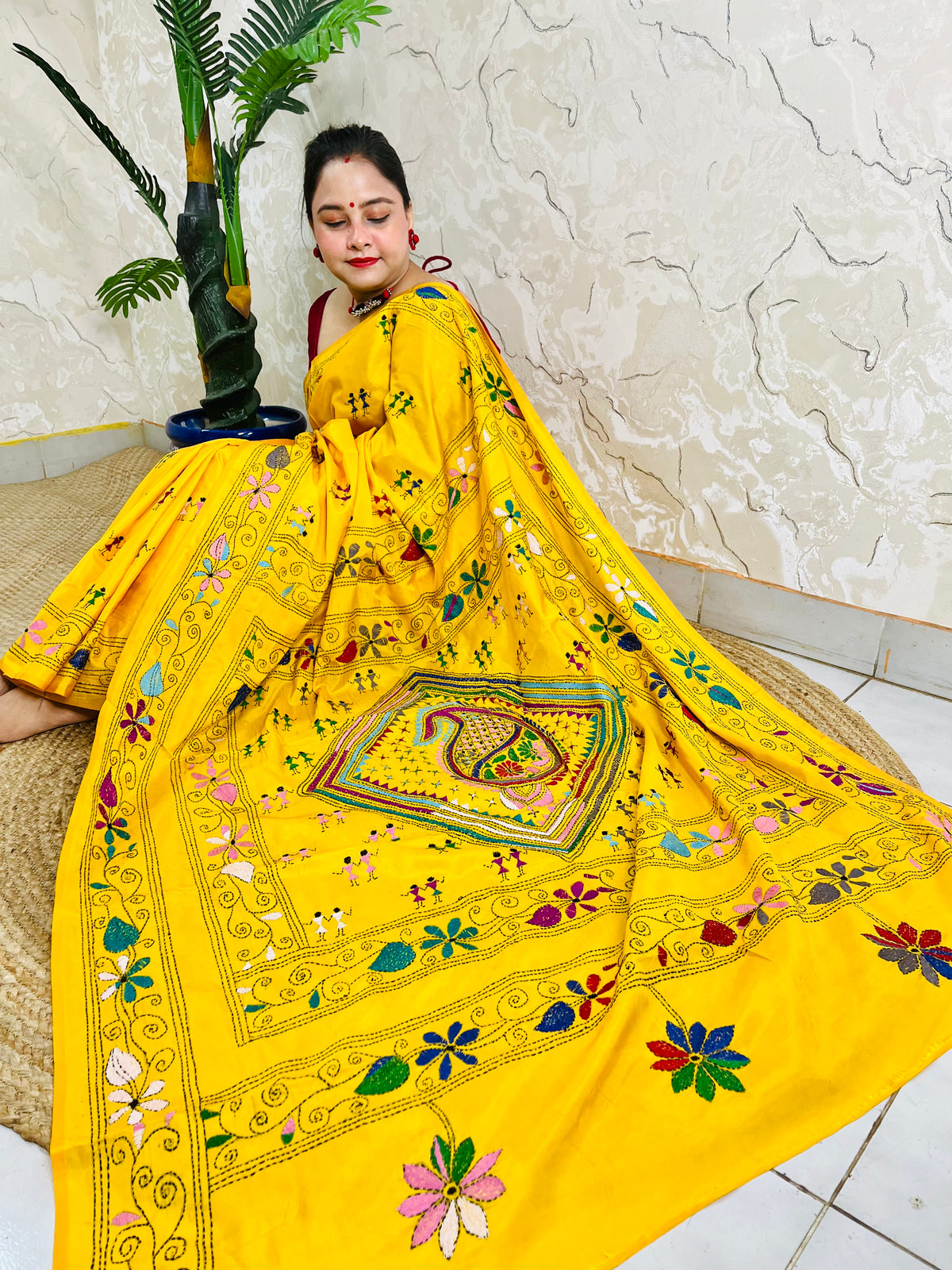 Yellow Kantha stitch saree with paisley pallu, full drape seated pose