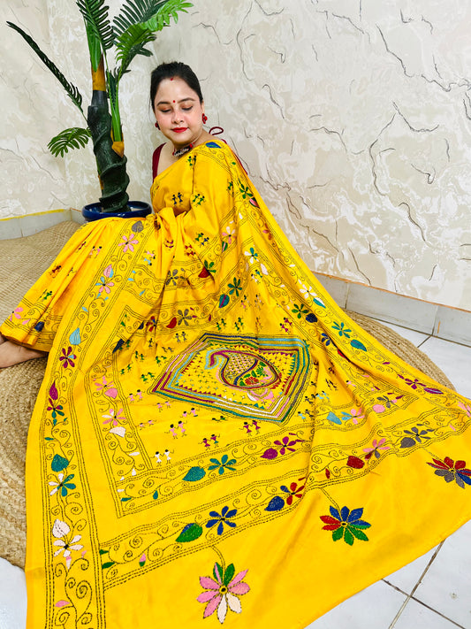 Yellow Kantha stitch saree with paisley pallu, full drape seated pose