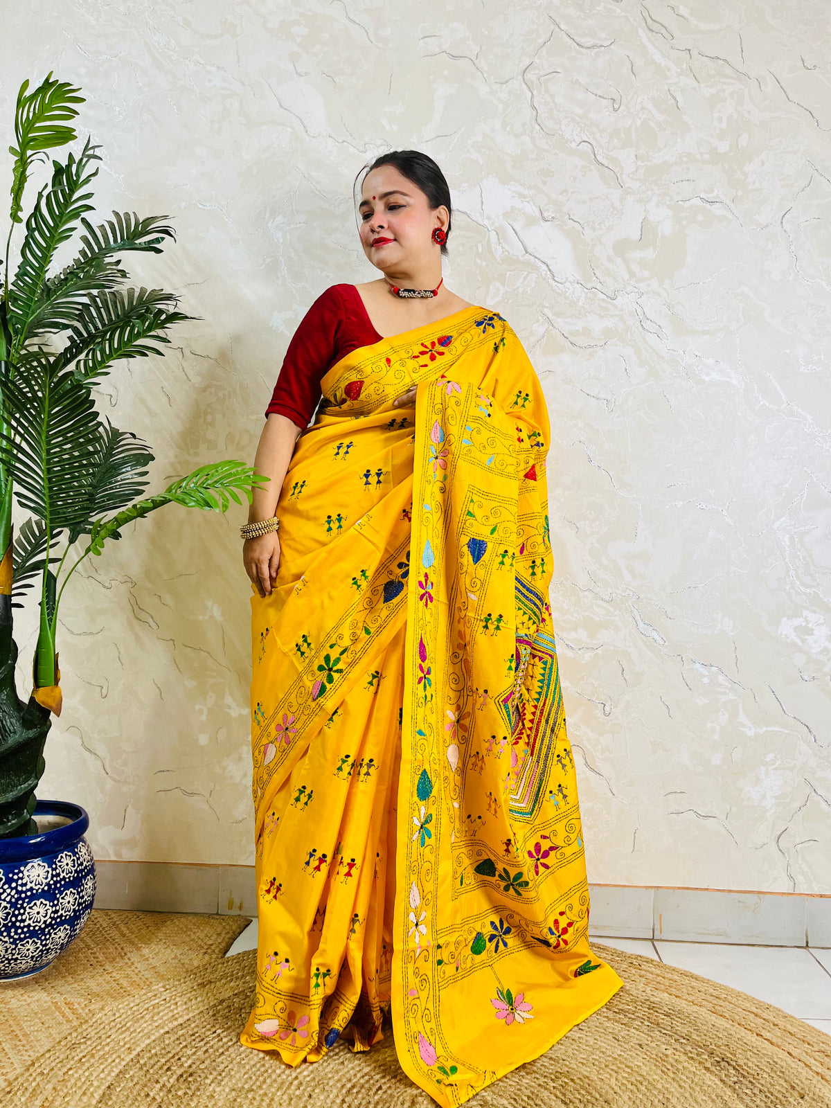 Yellow handwoven saree back drape showing floral border embroidery detail