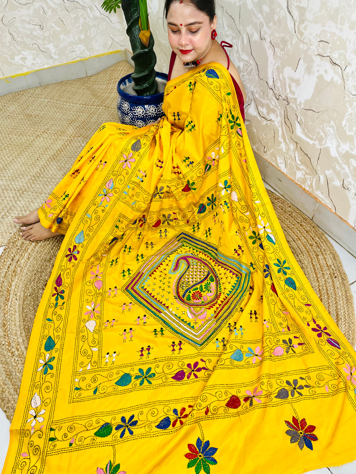 Yellow Kantha stitch saree with paisley pallu, full drape seated pose